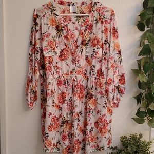 Women's pink and orange fall colored floral top.